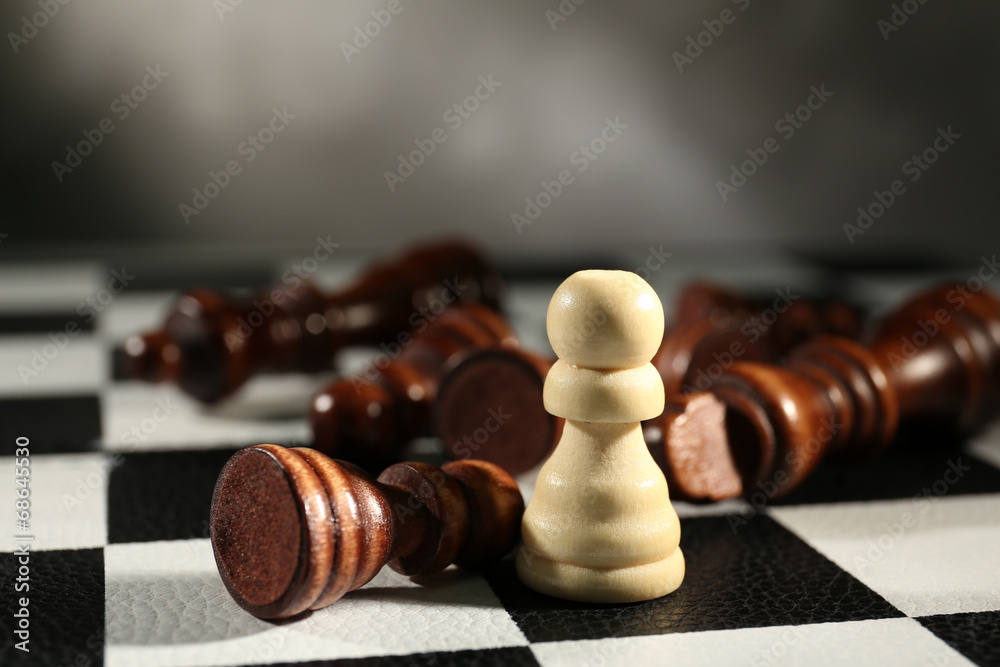 Chess board with chess pieces on grey background Chess board with chess pieces on grey background