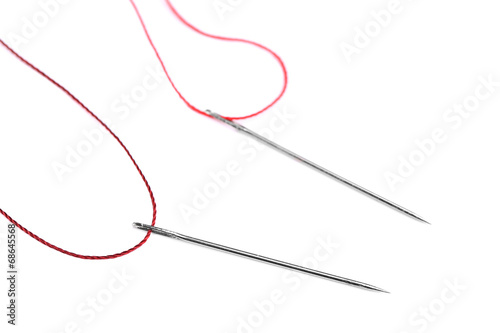 Needles and thread isolated on white © Africa Studio