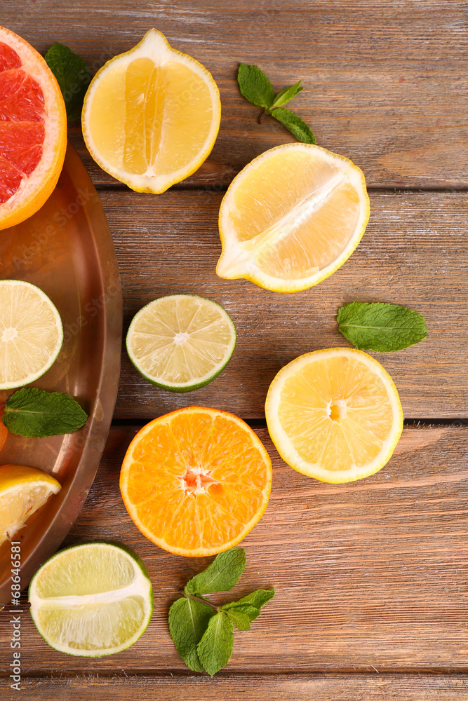 Different sliced juicy citrus fruits on wooden table Different sliced juicy citrus fruits on wooden table