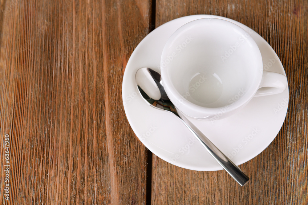 Empty cup with tea spoon on wooden background Empty cup with tea spoon on wooden background