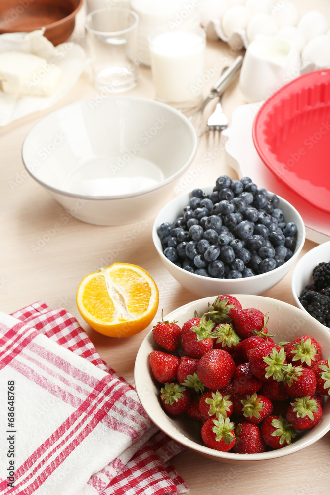 Baking tasty pie and ingredients for it on table in kitchen Baking tasty pie and ingredients for it on table in kitchen