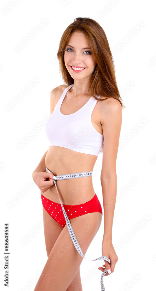 Obraz premium Young woman with orange and measuring tape isolated on white