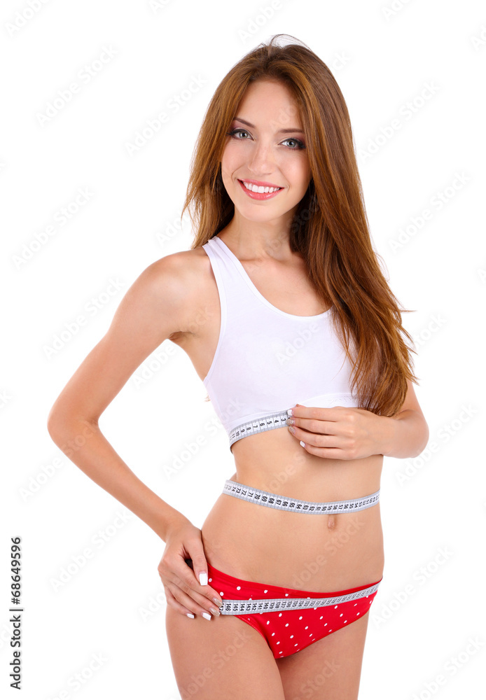 Obraz premium Young woman with orange and measuring tape isolated on white