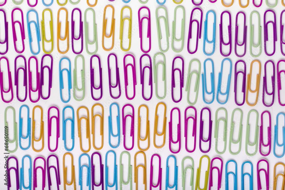 vertical lines of colorful office paper clips 