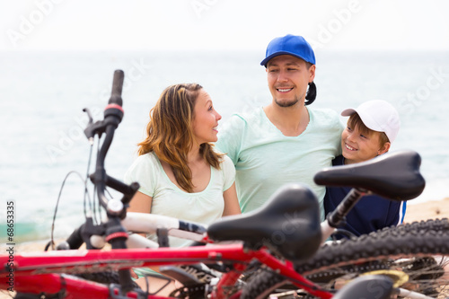 Happy family having rest after cycling