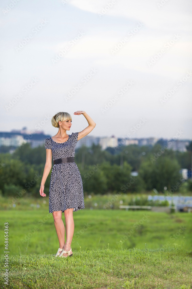Woman in field looks in a distance