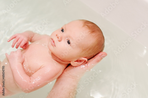Newborn baby in a bath