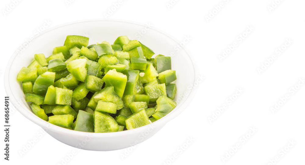 Chopped green capsicums in white bowls over white background Chopped green capsicums in white bowls over white background