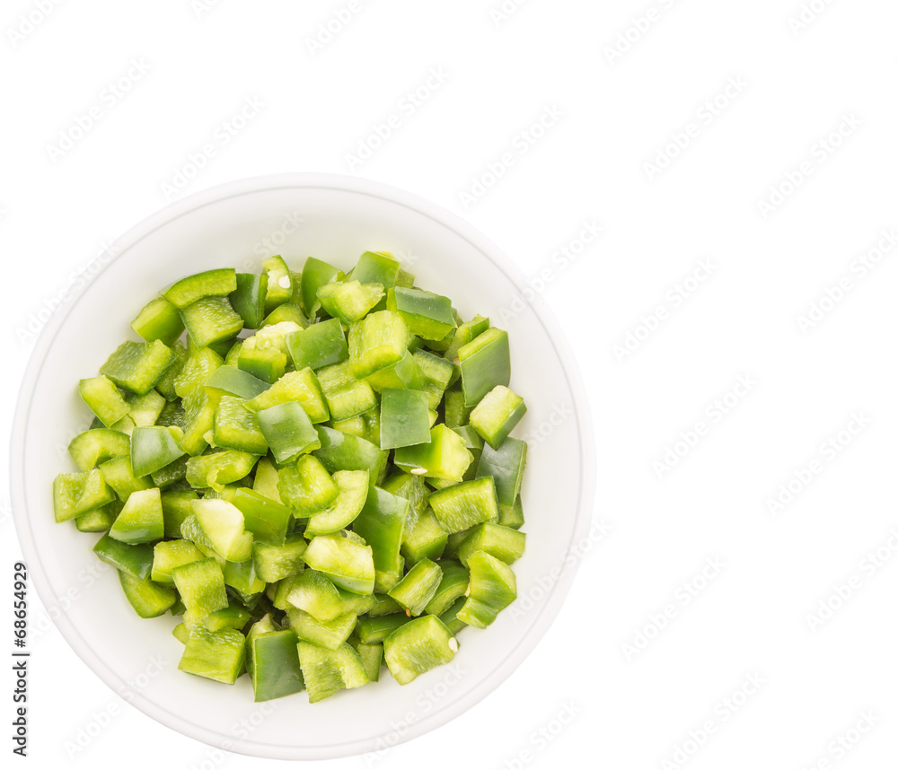 Chopped green capsicums in white bowls over white background Chopped green capsicums in white bowls over white background