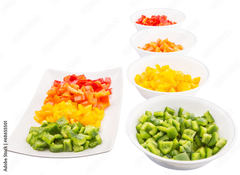 Colorful chopped capsicums in a plate and bowls Colorful chopped capsicums in a plate and bowls