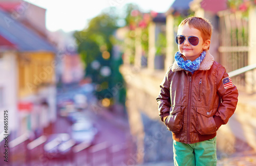 stylish kid walking city street, autumn fashion