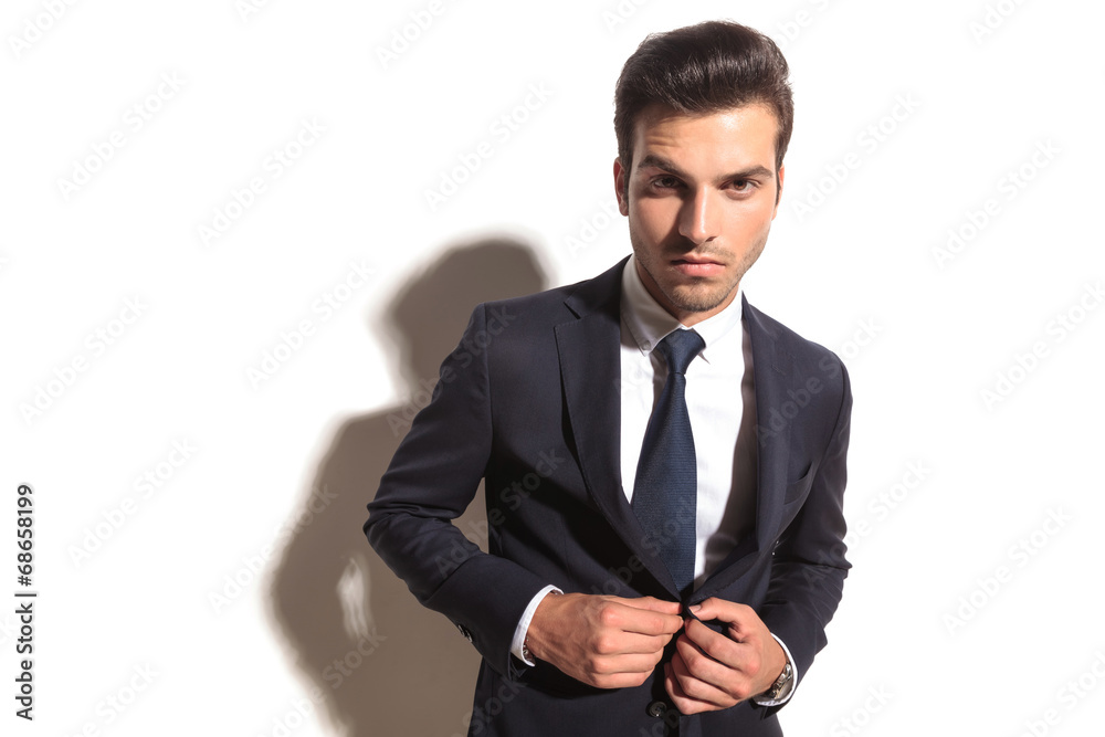 dramatic fashion business man unbottoning his coat dramatic fashion business man unbottoning his coat