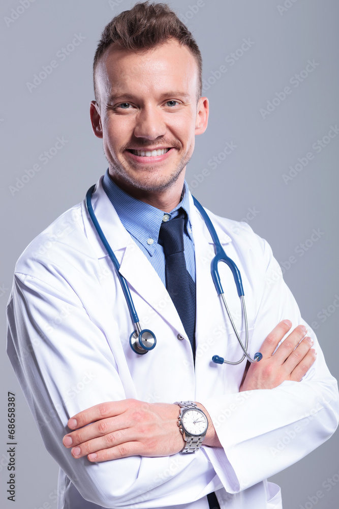 young doctor with hands crossed young doctor with hands crossed