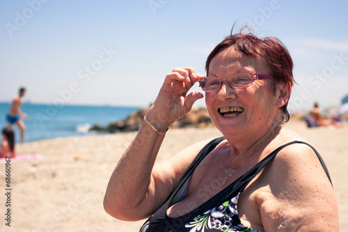 Happy senior woman on the beach