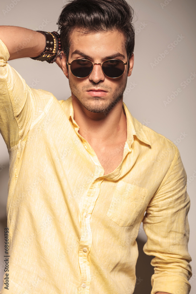 relaxed fashion man with hand on head relaxed fashion man with hand on head