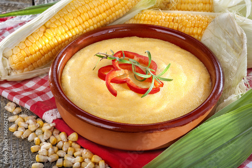 corn grits polenta in a bowl on old wooden table