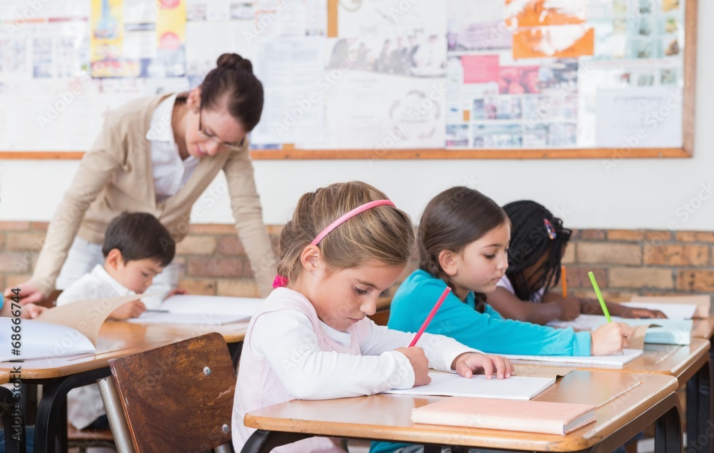 Cute pupils drawing at their desks Cute pupils drawing at their desks