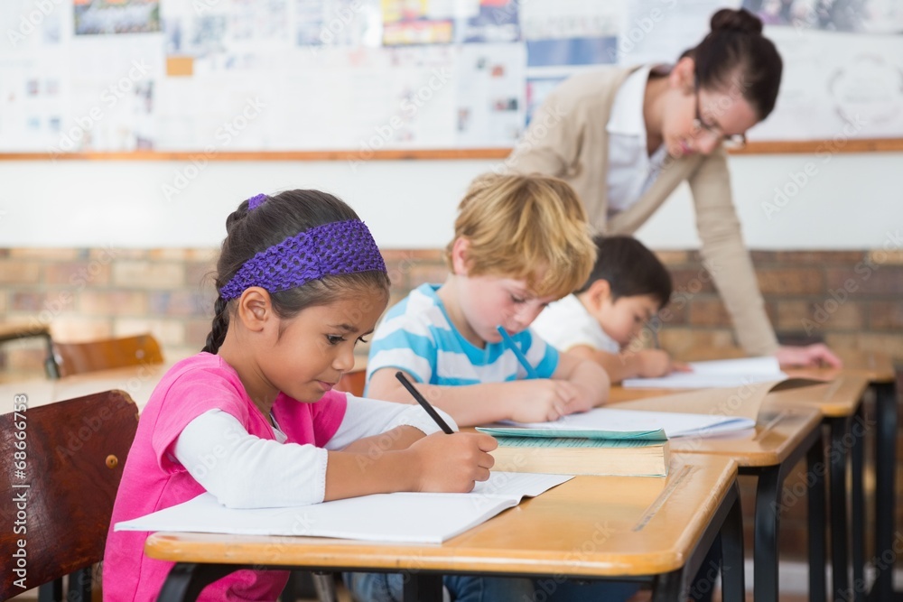 Fototapeta premium Cute pupils drawing at their desks