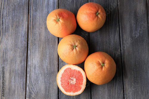 Ripe grapefruits on wooden background