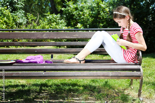 Cute girl drawing on bench ...