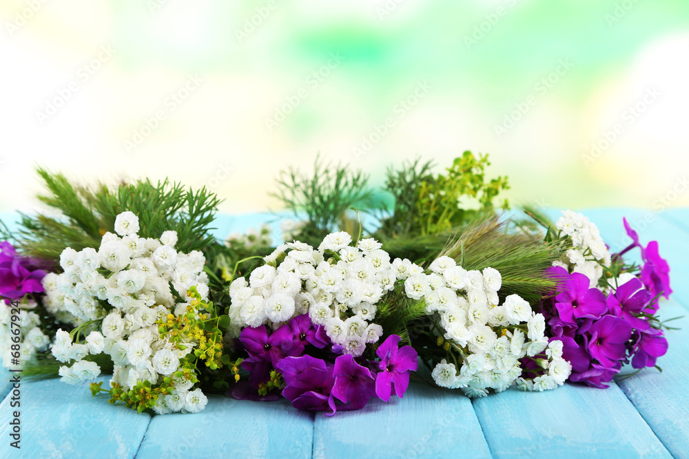 Flower wreath on table on nature background