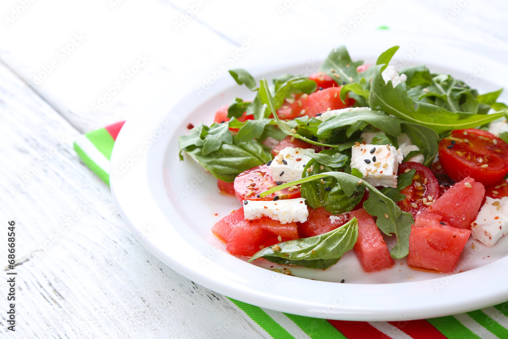 Salad with watermelon,tomatoes,  feta, arugula and basil leaves