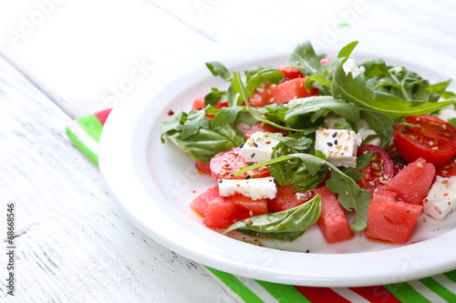 Salad with watermelon,tomatoes, feta, arugula and basil leaves