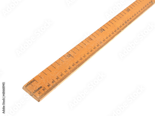 Close up photo of a wooden meteric ruler on a white dackground.