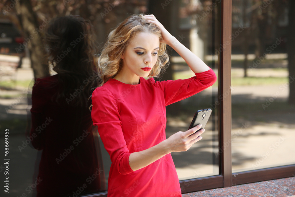 Fototapeta premium Beautiful young girl outdoors near building