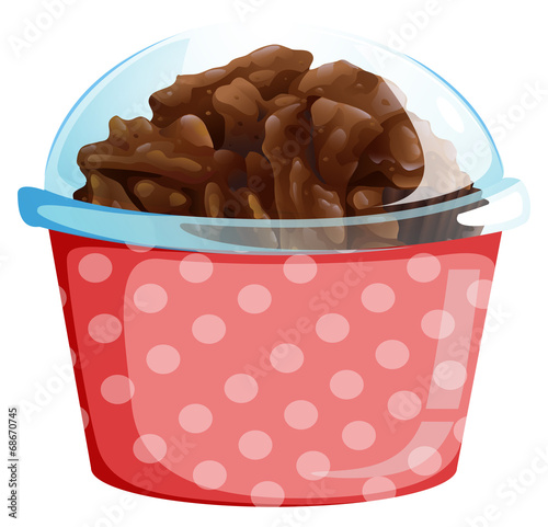 A cupcake inside the pink polkadot container