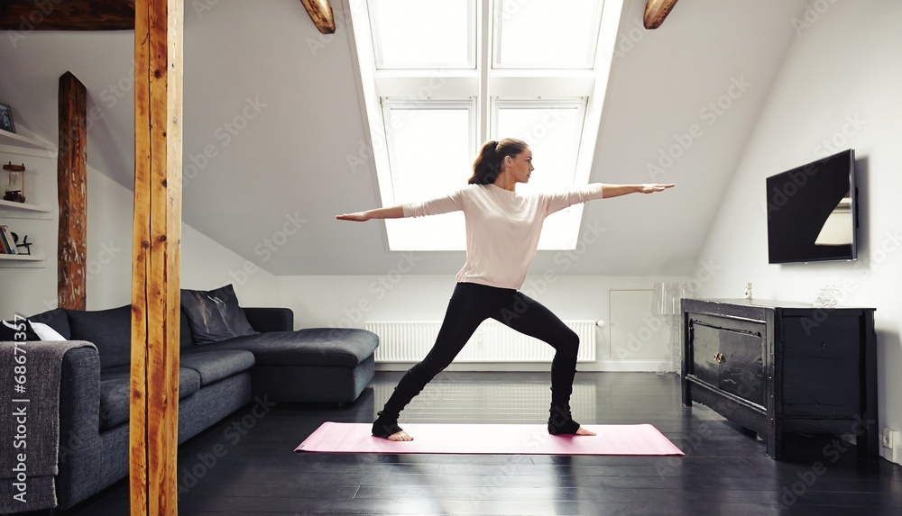Attractive young woman doing yoga at home Attractive young woman doing yoga at home