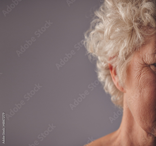 Schilderij op canvas Senior woman face with wrinkled skin