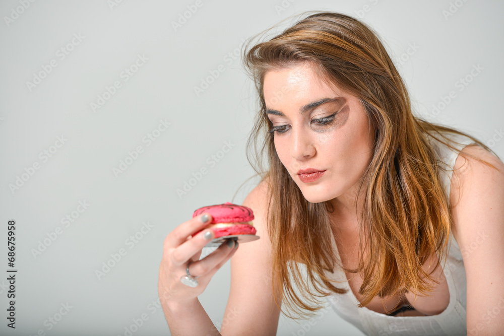 glamour make-up young woman eating pink macaroon glamour make-up young woman eating pink macaroon