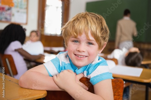Smiling pupil sitting at his desk © WavebreakMediaMicro