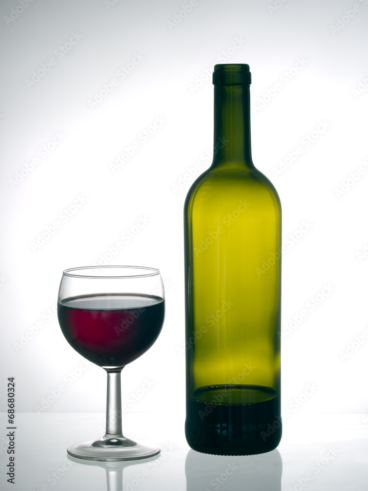 Finishing the bottle. Red wine glass and bottle. Finishing the bottle. Red wine glass and bottle.