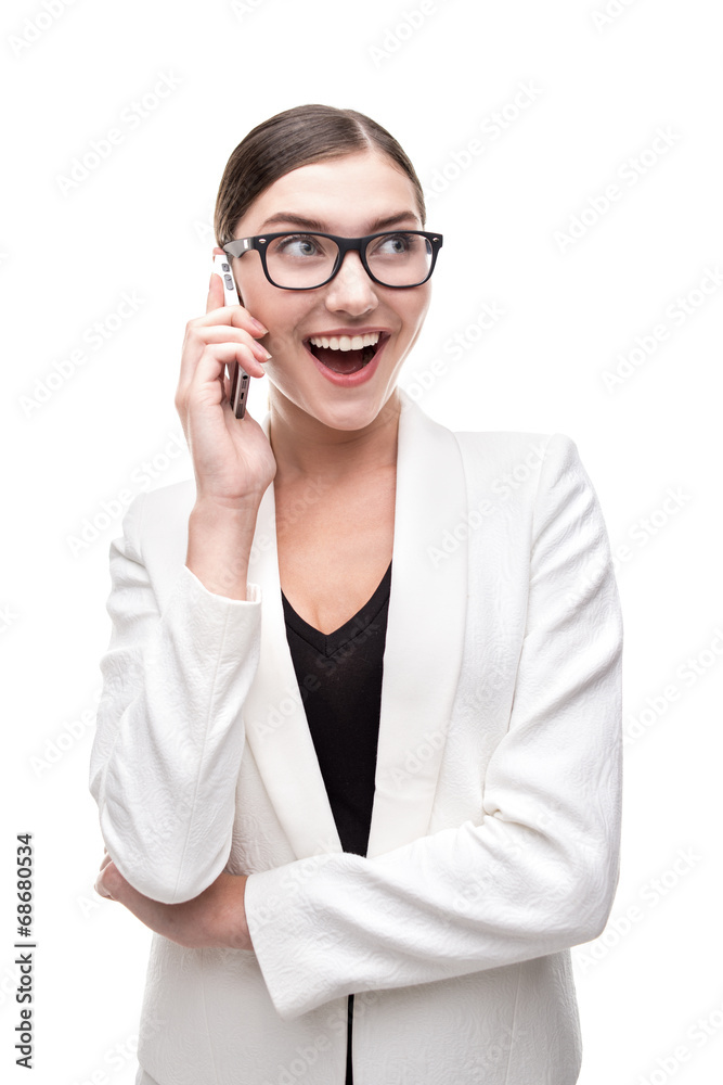 Exiting young business woman smiling and talking on smartphone