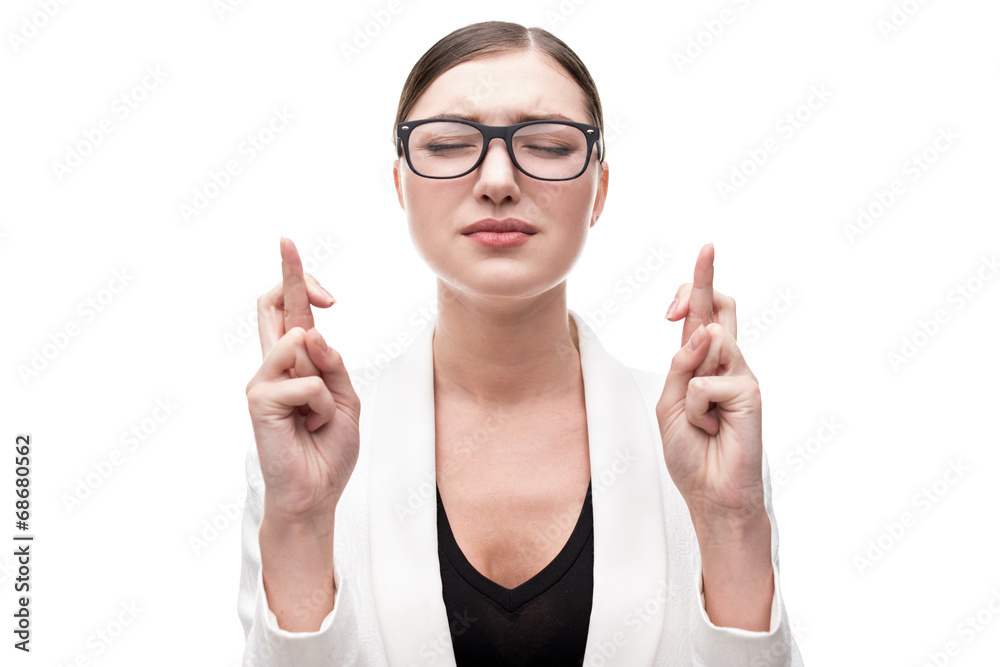 Young woman wishing or praying something with crossed fingers Young woman wishing or praying something with crossed fingers