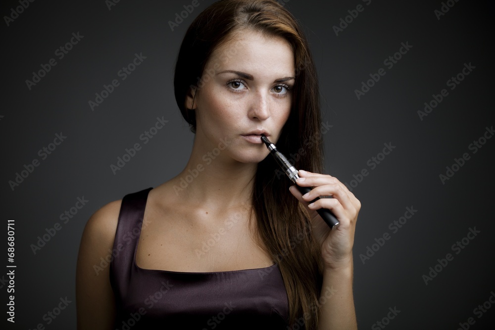 Elegant beautiful woman holding e-cigarette Elegant beautiful woman holding e-cigarette
