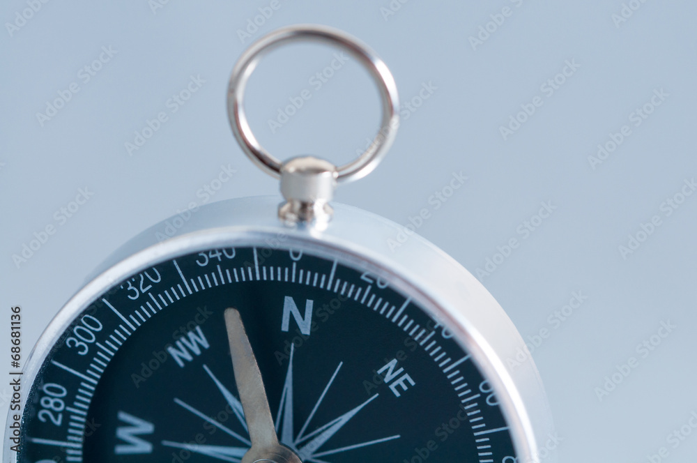Compass on the grey background. Studio shot. Close-up. Compass on the grey background. Studio shot. Close-up.