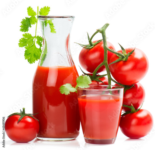 Bottle and glass of tomato juice and ripe tomatoes.