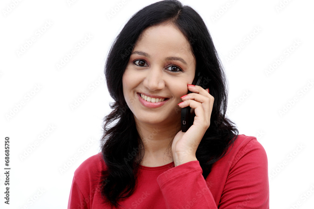 Happy young woman talking on mobile phone