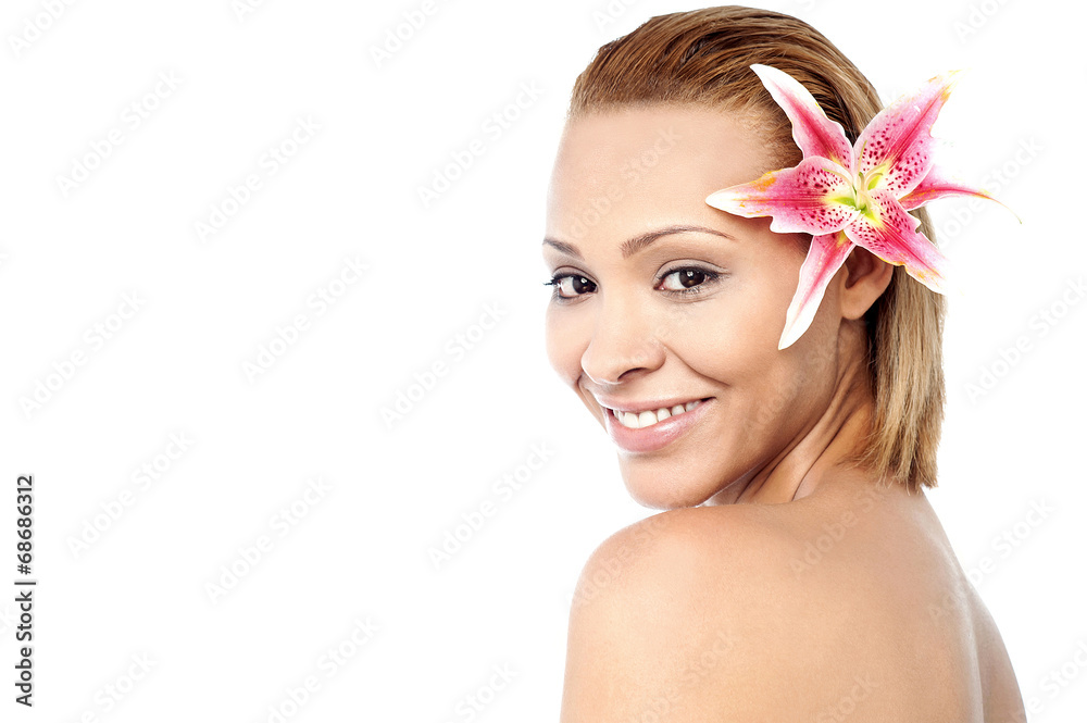 Smiling woman with pink lily flower Smiling woman with pink lily flower