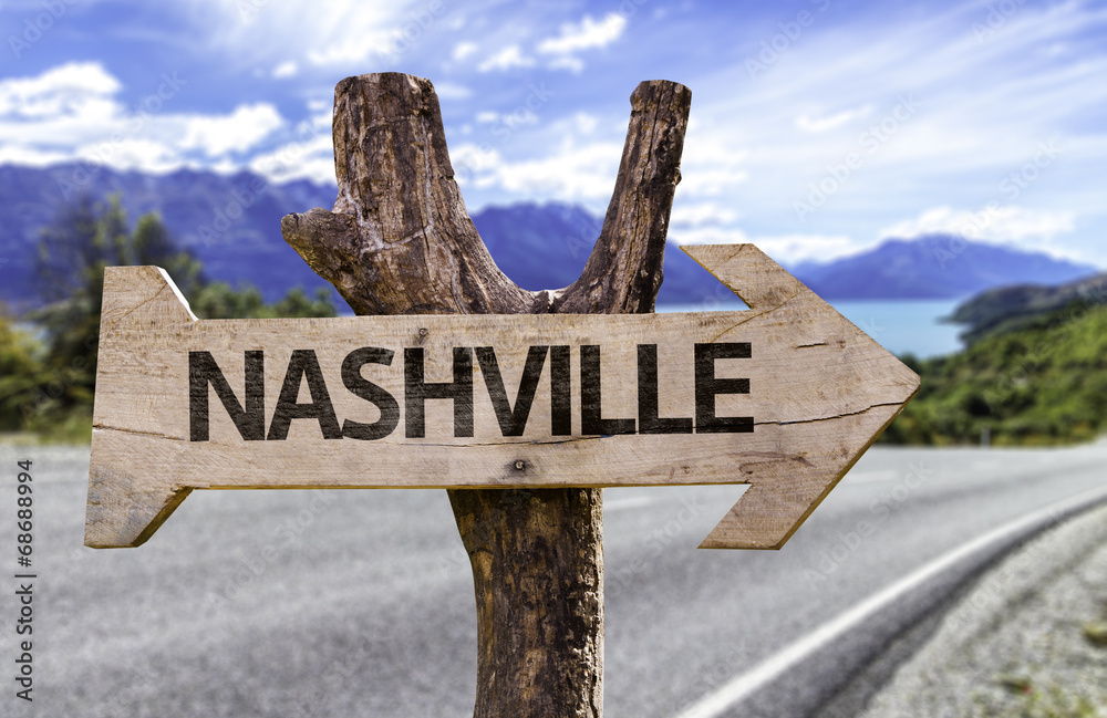 Nashville wooden sign with a street on background