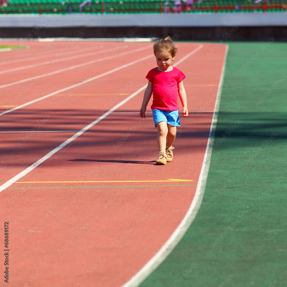 little girl child involved in athletics at the stadium