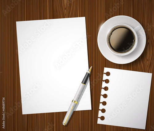 sheet of paper and a cup of coffee on a wooden table