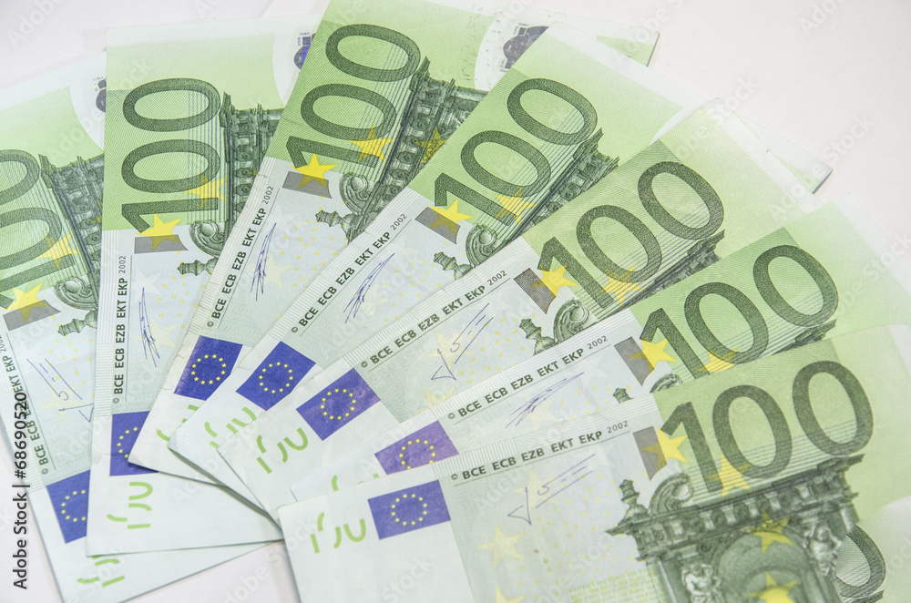 Close-up of 100 Euro banknotes isolated on white background. Close-up of 100 Euro banknotes isolated on white background.