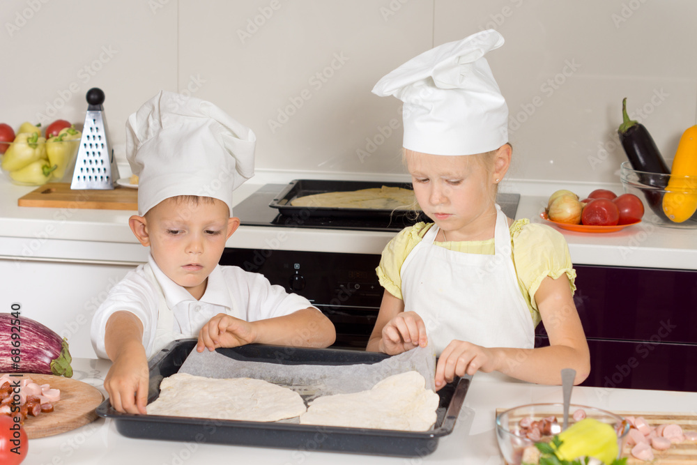 Little boy and girl making homemade pizza Little boy and girl making homemade pizza