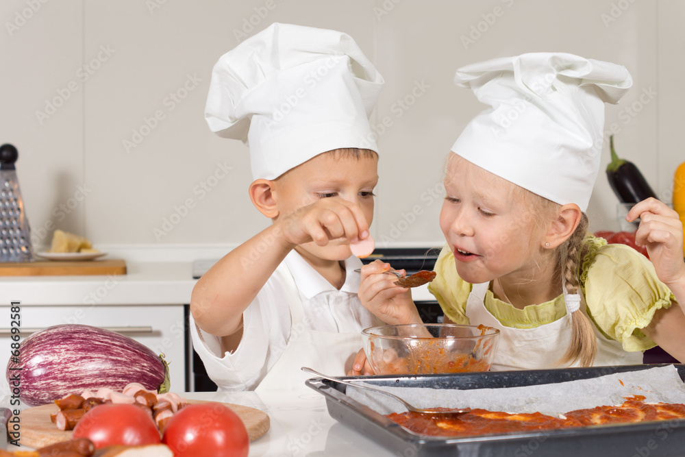 Cute Little Kids Tasting Sauce for Pizza Cute Little Kids Tasting Sauce for Pizza