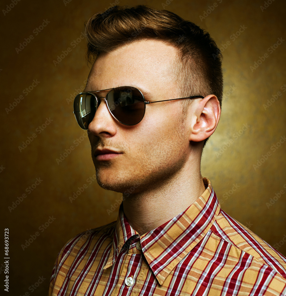 Сloseup portrait of a young casual man looking away from the ca Сloseup portrait of a young casual man looking away from the ca