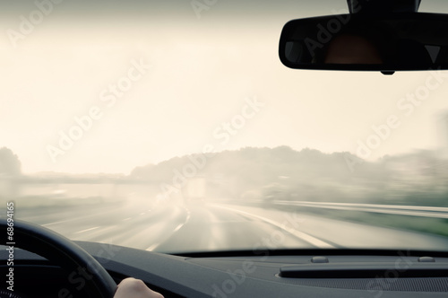 Driving on a Highway on a Rainy and Misty Day © trendobjects